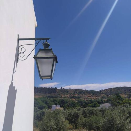 a street light on the side of a white building at Casa do Forno Évora retreat in Redondo