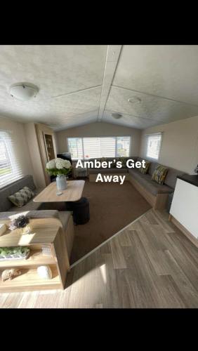 a living room with a couch and a table at Amber’s Get Away in Skegness