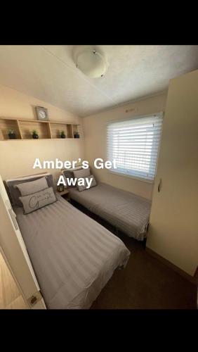 a bedroom with a bed and a window at Amber’s Get Away in Skegness