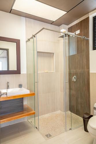 a bathroom with a shower and a sink at Guayupes Hotel de Aventura in Guamal