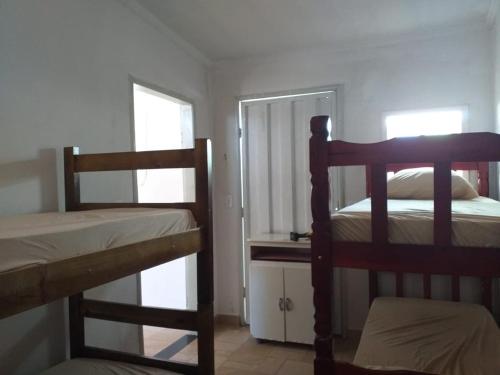 a bedroom with two bunk beds and a mirror at Hostel Bimba Goiânia - Unidade 01 in Goiânia