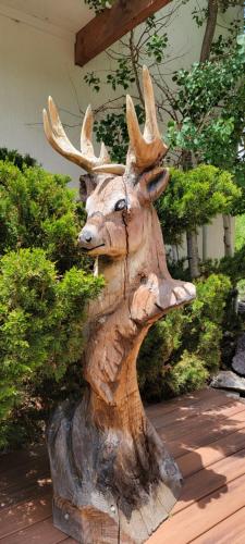 a statue of a moose head on a stump at Hot Springs Inn in Ouray