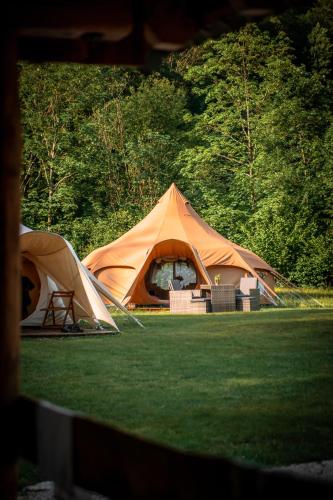 a couple of tents sitting on the grass at Glamping Gozdna Jasa in Bovec