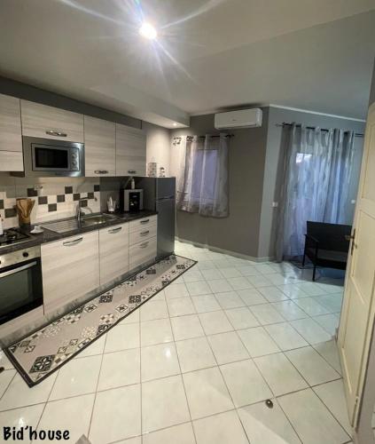 a kitchen with a large white tiled floor at isola rossa fronte mare apartment in Isola Rossa