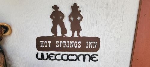 a drawing of three people on a sign with the words not springs anymore at Hot Springs Inn in Ouray