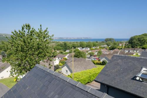 an aerial view of a residential neighborhood with roofs at Ty Alice in Oxwich