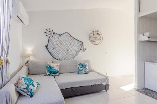 a living room with a couch with blue pillows at Arien in Cala en Blanes