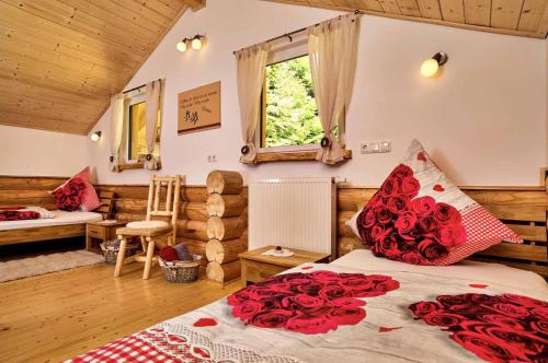 a bedroom with a bed with red roses on it at Chalet Blumental in Neuschönau
