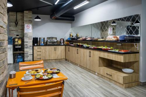 a kitchen with a table with food on it at The Queen Hotel in Istanbul