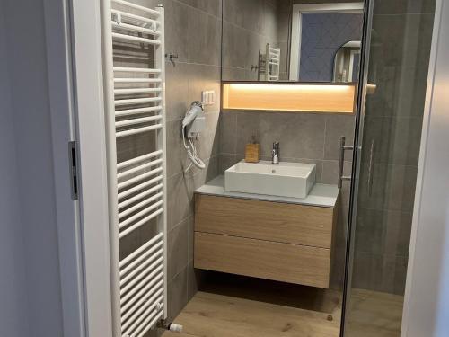 a bathroom with a sink and a mirror at A comfortable apartment for 3 people in Pobierowo in Pobierowo