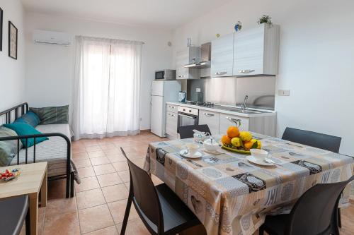 a kitchen with a table with a bowl of fruit on it at Casa Del Corso in Motta Camastra