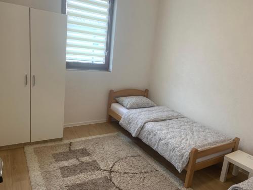 a bedroom with two twin beds and a window at Apartment Kraljevac in Visoko