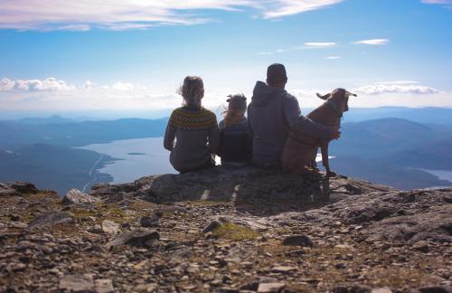 a group of three people sitting on top of a mountain at Lapland Hotels Kilpis in Kilpisjärvi
