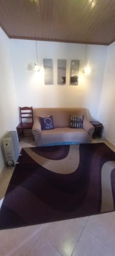 a living room with a couch and a rug at Cantinho da Avó in Vila do Bispo