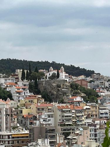a view of a city with buildings on a hill at Vasilis Garden House in Kavala