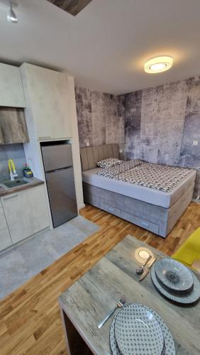 a room with a bed and a table with plates at XYZ-Osijek in Osijek