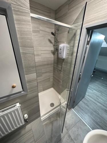 a shower with a glass door in a bathroom at Gulson Estates B&B in Parkside