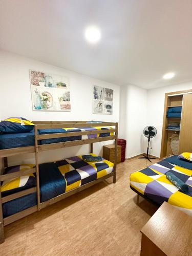 a bedroom with two bunk beds and a desk at Apartment en Rambla in Alicante