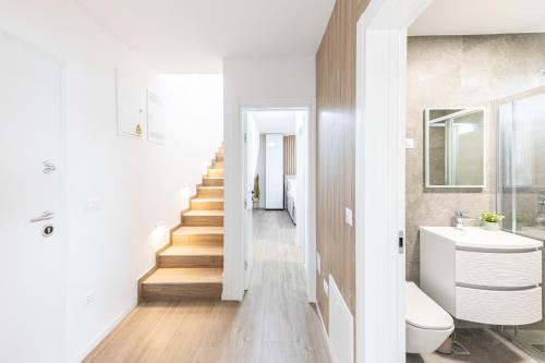 a bathroom with a staircase and a toilet and a sink at Salt&Soul Residence in Povljana