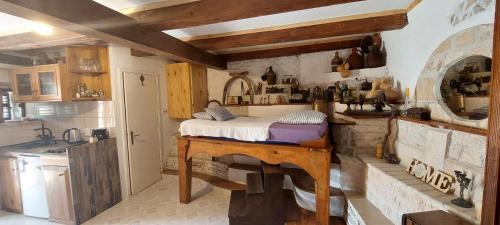 a bedroom with a bed on a wooden table at Taverna -Sunce- with jacuzzi in Vis