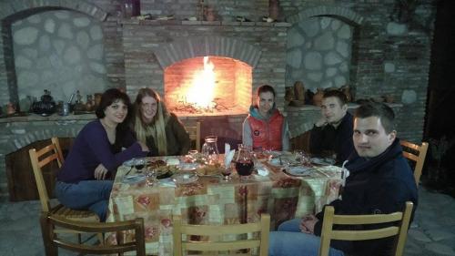 a group of people sitting around a table at Guest House Kusika in Sighnaghi
