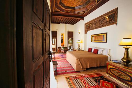 a hotel room with a bed and a door at Riad du Ciel Marrakech in Marrakesh