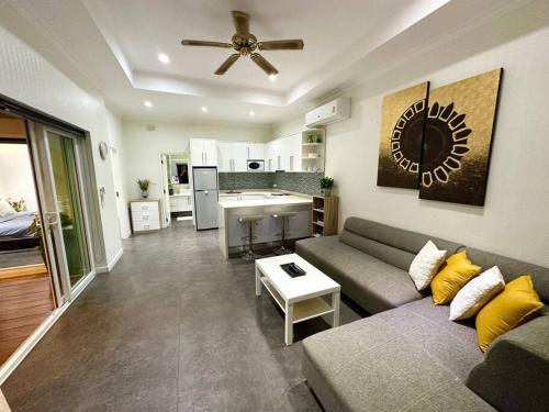 a living room with a couch and a kitchen at View Talay Villas - Luxury, 1 Bedroom - private pool villa, 500m from Jomtien beach - VTV 170 in Jomtien Beach