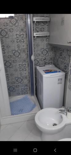 a bathroom with a shower and a toilet and a sink at il colibri' in Procida