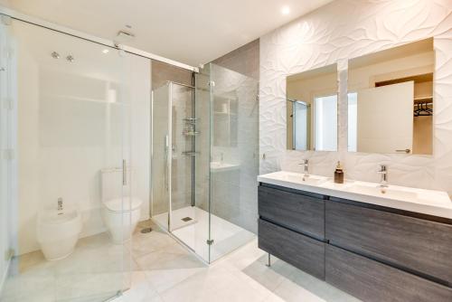 a bathroom with a sink and a shower and a toilet at Penthouse with private pool in La Cala de Mijas