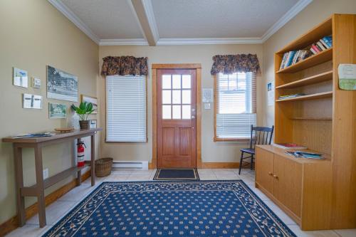 a room with a door and a desk and a rug at Iconic 3-Story Waterfront 'Marina House' w/ View in Gibsons