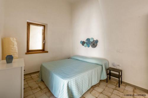 a bedroom with a bed and a mirror on the wall at Casa Mimina in Ischia