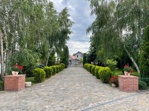 a walkway with a row of bushes and trees at Casa Dobra in Dobra