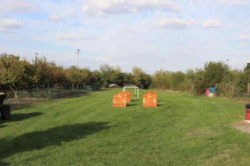 two signs in the middle of a grass field at Casa Dobra in Dobra
