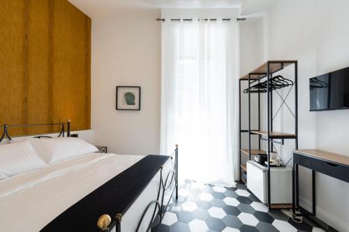 a bedroom with a bed and a black and white checkered floor at Al 4 Piano in Naples