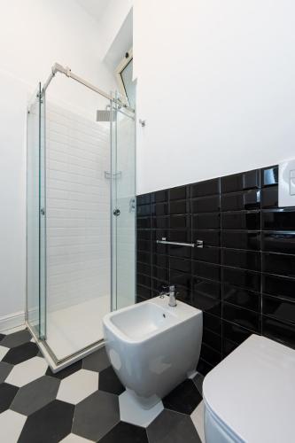 a bathroom with a toilet and a glass shower at Al 4 Piano in Naples