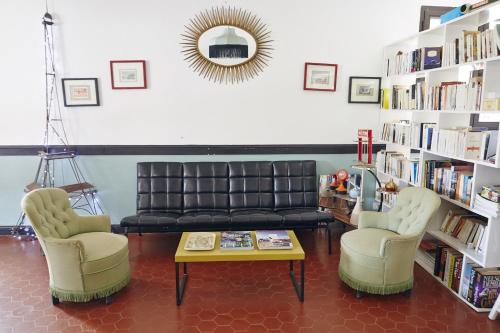 a living room with a couch and two chairs and a table at Chez Marie in Linguizzetta