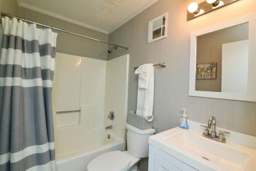 a bathroom with a toilet and a sink and a shower at Sweet Caroline Remodeled with Partial Ocean View and Oceanfront Pool in Myrtle Beach