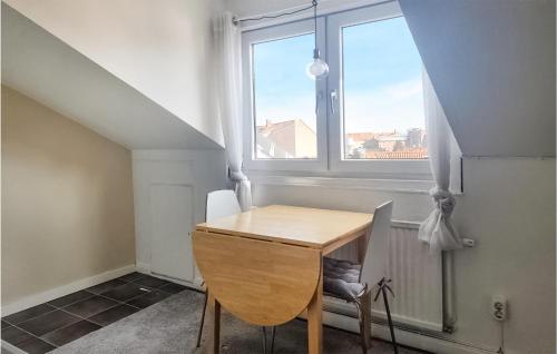 a table and chair in a room with a window at Amazing Apartment In Ystad With 1 Bedrooms in Ystad