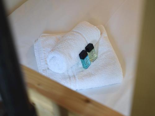 a stack of towels and a bottle of soap at Pass the Keys Beautiful Family Home Sleeps 6 in Emsworth