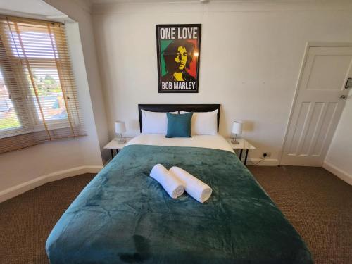 a bedroom with a large bed with two towels on it at Solihull Shared House in Birmingham