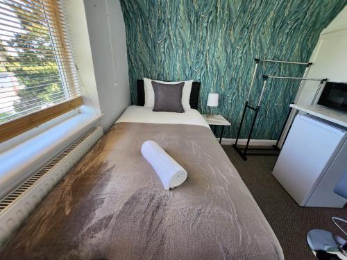 a bedroom with a bed with a pillow on it at Solihull Shared House in Birmingham