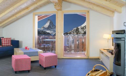 a living room with a view of a mountain at Haus Leopold in Zermatt