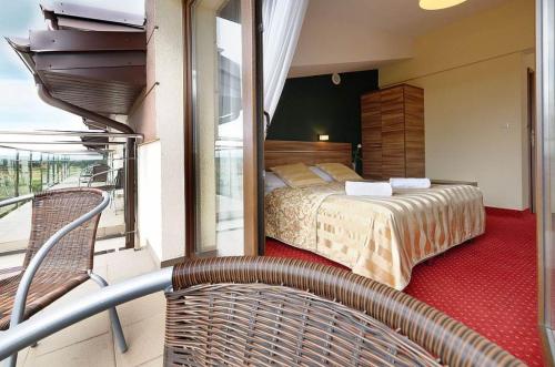 a hotel room with a bed and a balcony at Hotel Luzino in Luzino