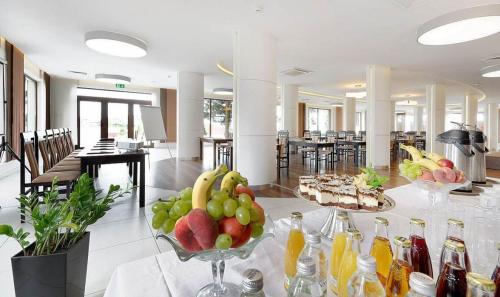 a table with a bowl of fruit on top of it at Hotel Luzino in Luzino