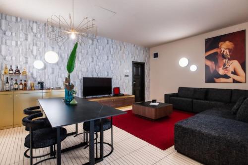 a living room with a couch and a table at Stories Boutique Hotel in Budapest