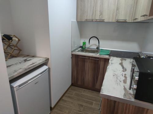a kitchen with a sink and a counter top at In Dream Apartman in Inđija