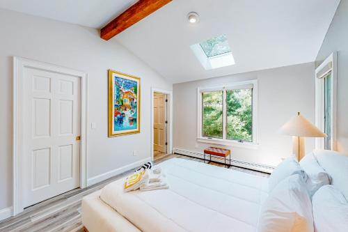 a living room with a white couch and a window at Bourne Glen in Bourne