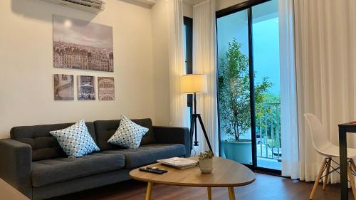 a living room with a couch and a table at Cozy place @ Chiangrai in Chiang Rai
