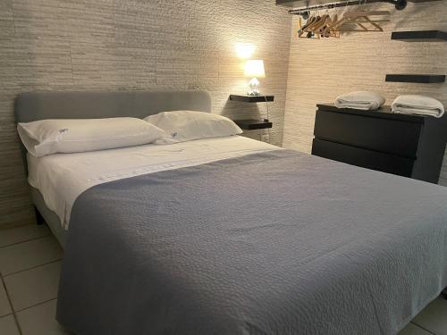 a bedroom with a large bed with white sheets and pillows at Villa Avvocato Catapano in Pontecagnano