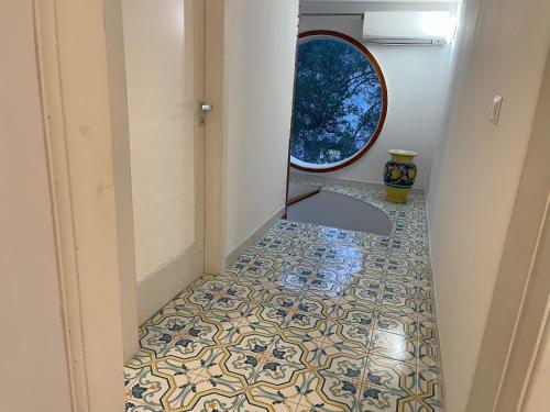 a hallway with a tile floor and a window at Villa Avvocato Catapano in Pontecagnano